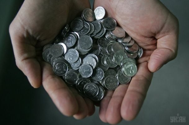 Hryvnia and kopiykas on table