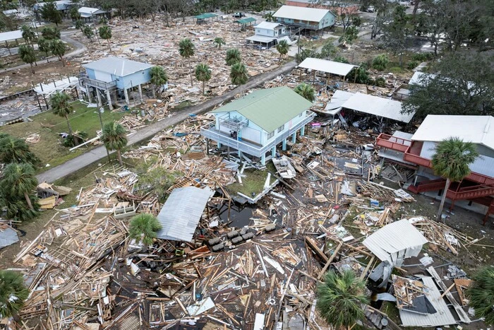 Fallen trees and flooded houses