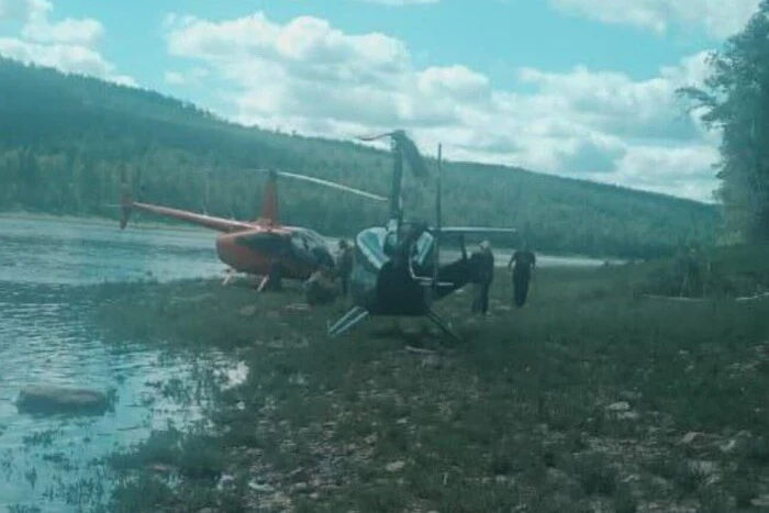 Crashed cargo helicopter against the forest background