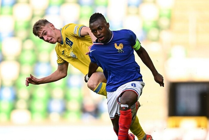 Sad player in a jersey with the national flag