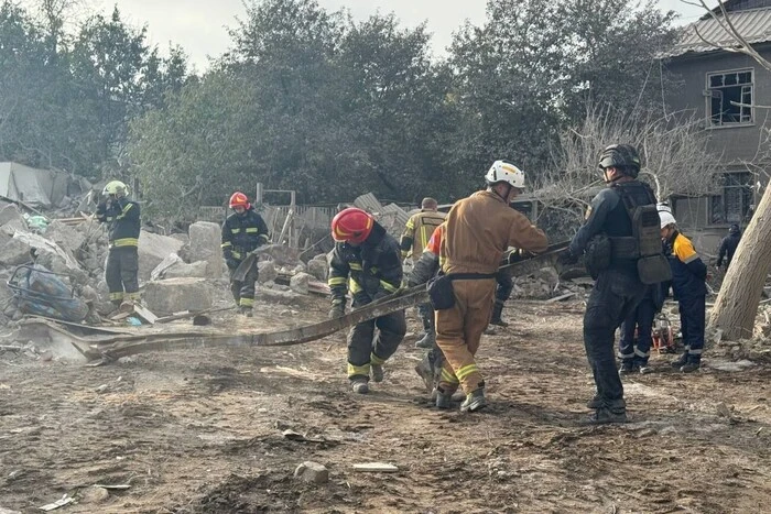 The photo shows the ruins of a destroyed house