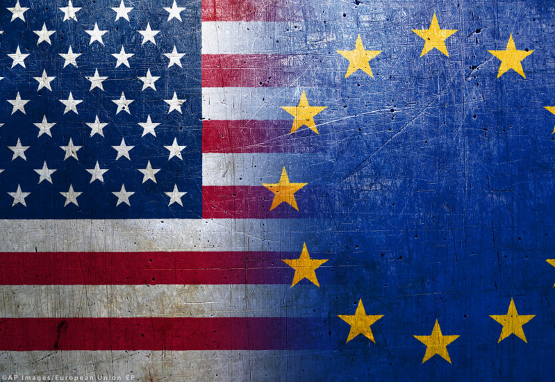 The photo shows the flags of the United States and the European Union