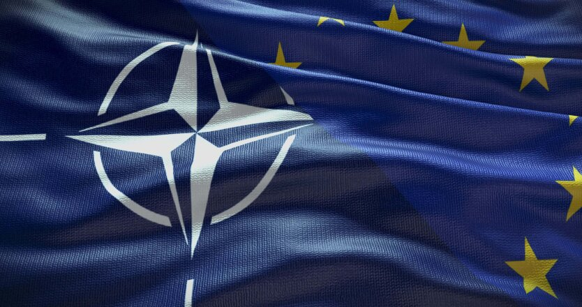 Flags of EU and NATO at a meeting