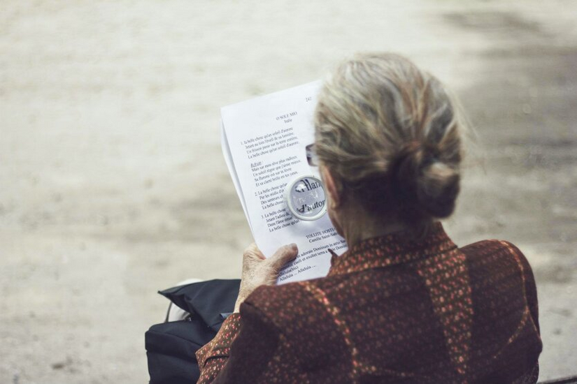 Retiree in the garden with a book