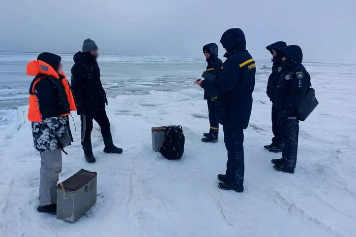 rescuers lifting people from the ice floe