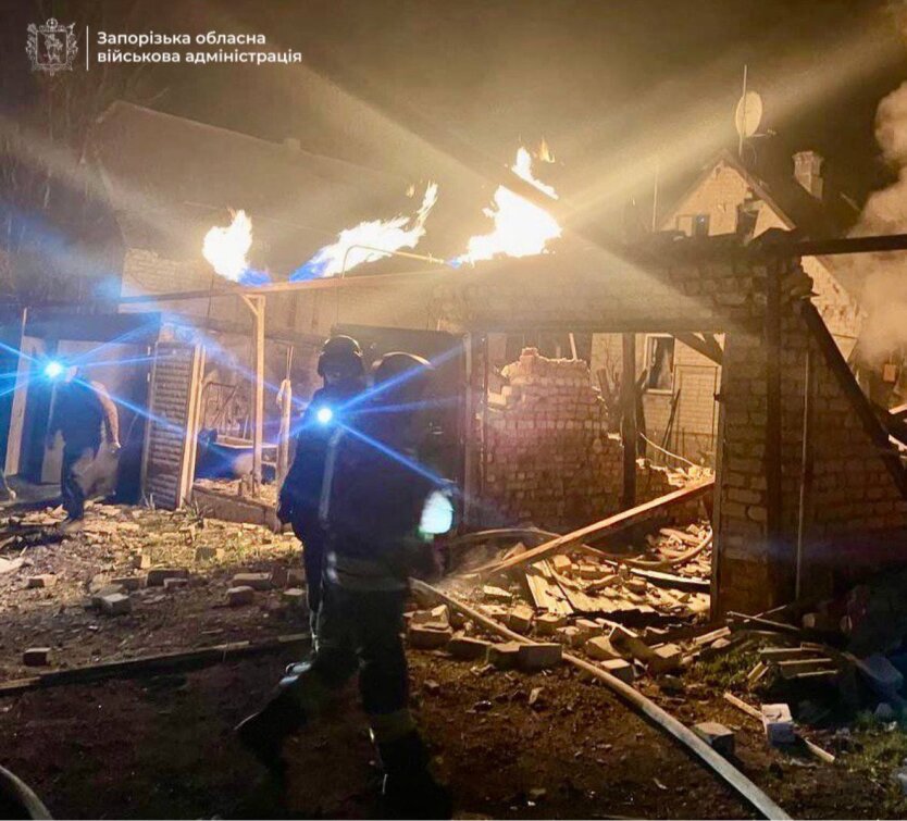 Damaged apartment buildings and an injured woman