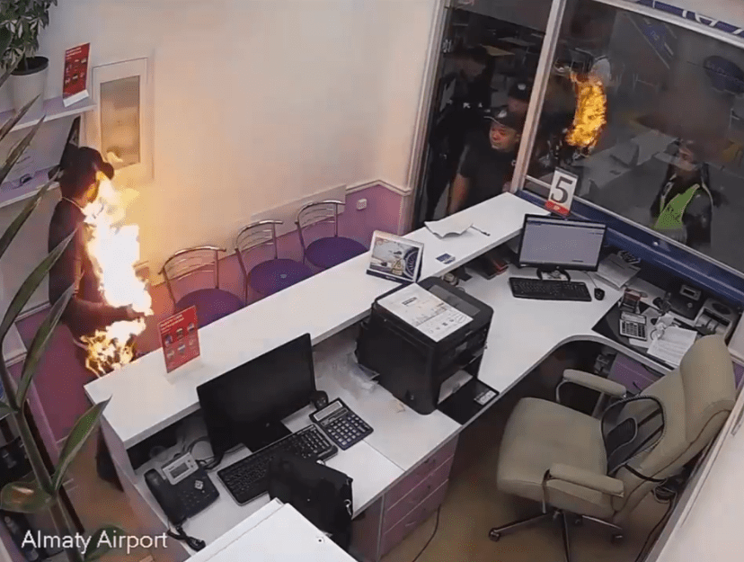 Horror moment man sets himself on FIRE at busy airport in front of screaming travellers after ‘missing his flight’