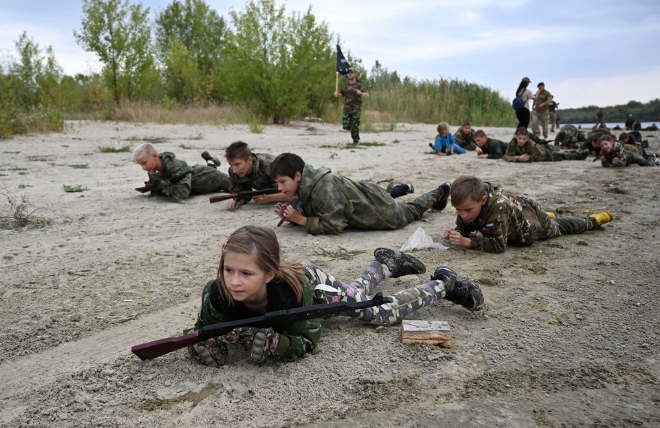 Chilling moment Russian kids crawl with AK-47s & throw grenades as Vladimir Putin prepares his next generation army